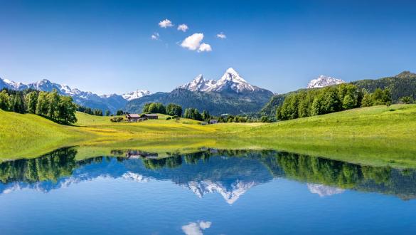Panoramic view of idyllic summer landscape in the Alps with clear mountain lake and fresh green mountain pastures in the background; Shutterstock ID 263027252; purchase_order:Not applicable; job:Heusser; client:NA; other:NA