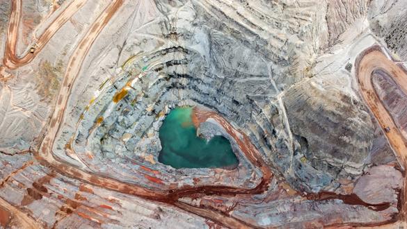 Brilliant colors explode in a vertical view of an open pit mining from above