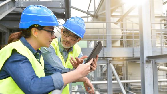 Industrial engineers working in recycling plant with tablet