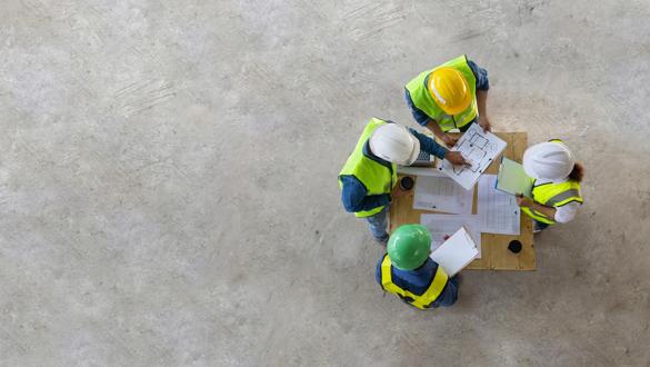 Top view of engineer, architect, contractor and foreman are meeting at the construction building site with floor plan for real estate development project industry and housing timeline usage