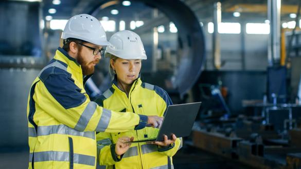Male and Female Industrial Engineers in Hard Hats Discuss New Project while Using Laptop. They Make Showing Gestures.They Work in a Heavy Industry Manufacturing Factory / HR
WebDAM Path: /Photography & Illustration/Stock Photography/People