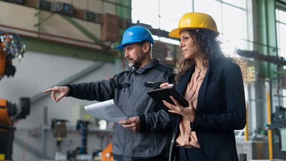 Female engineering manager and mechanic worker inside the factory