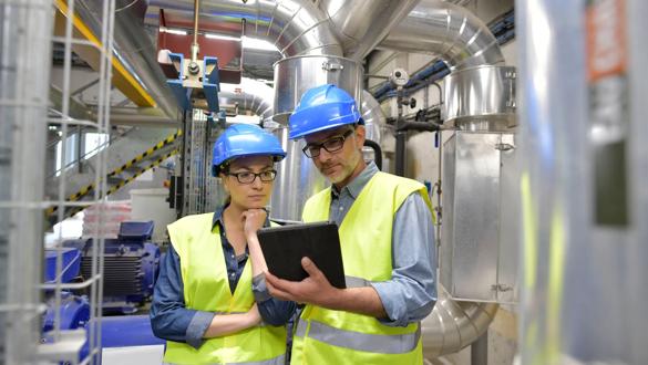 Industrial engineers working in recycling plant with tablet