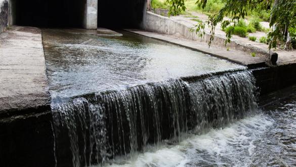 Water stream flowing out the underground tunnel into the Lybid river in Kyiv.