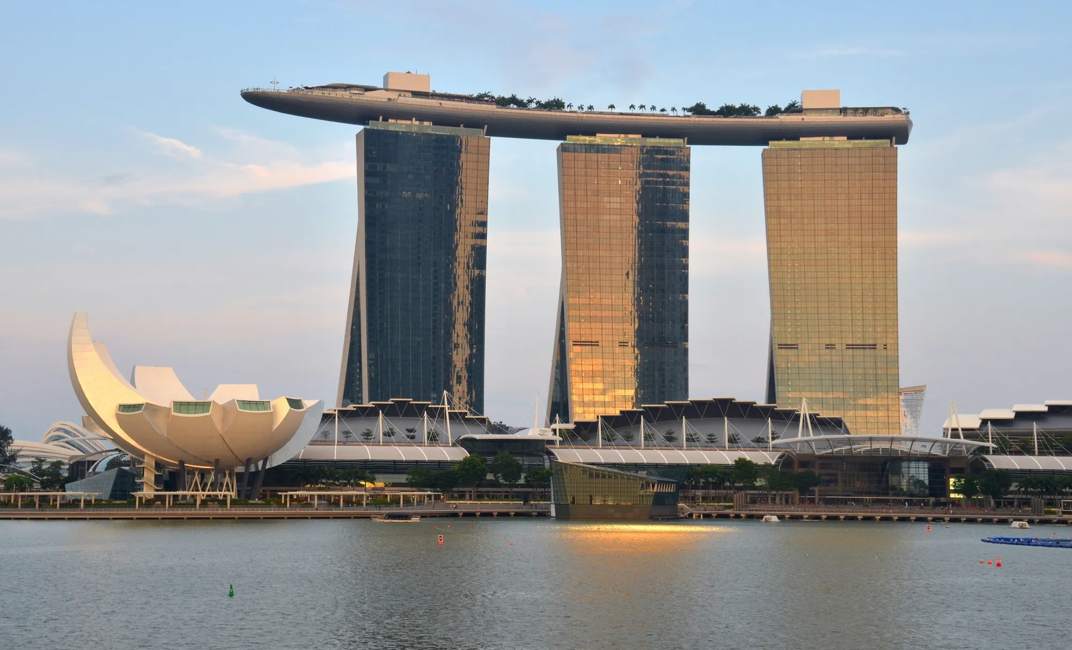 The Marina Bay Sands Resort Hotel & The ArtScience Musuem in Singapore. Sunset view. It is an integrated resort & the worlds most expensive standalone casino property.