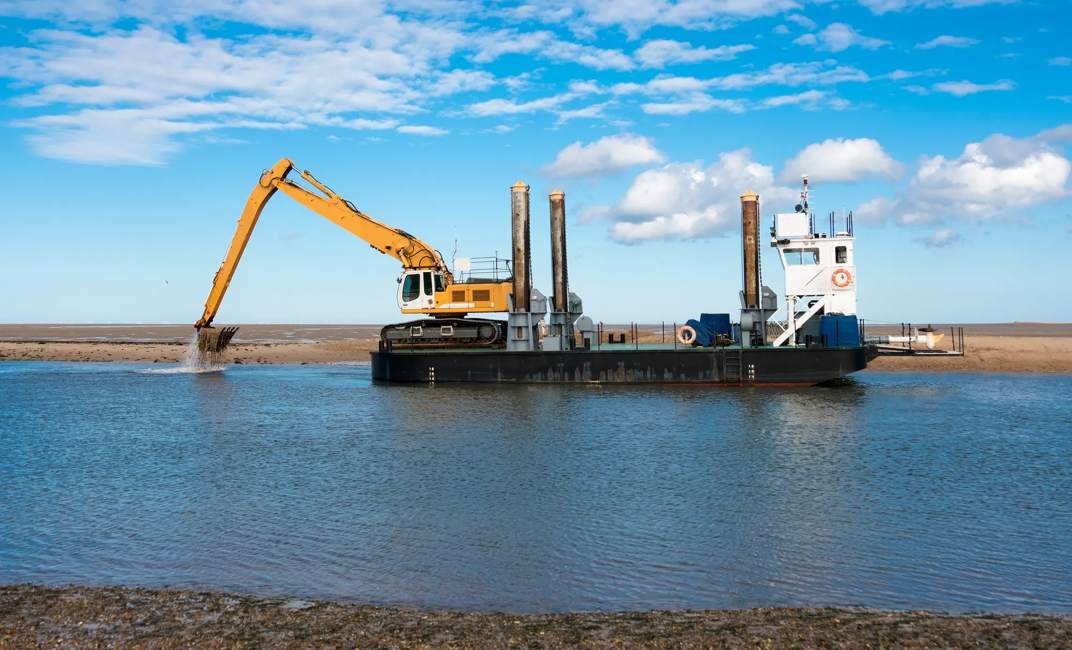 Excavator digging out a channel